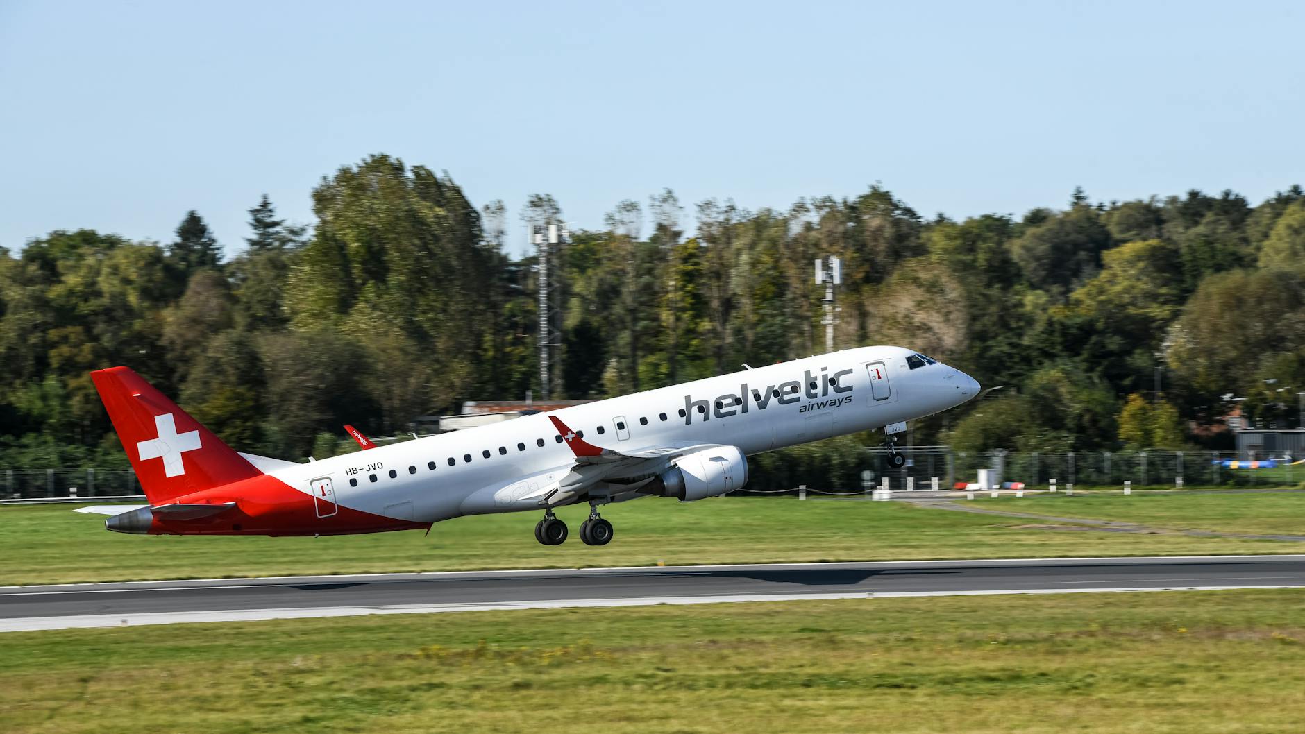 helvetic airways plane taking off on clear day